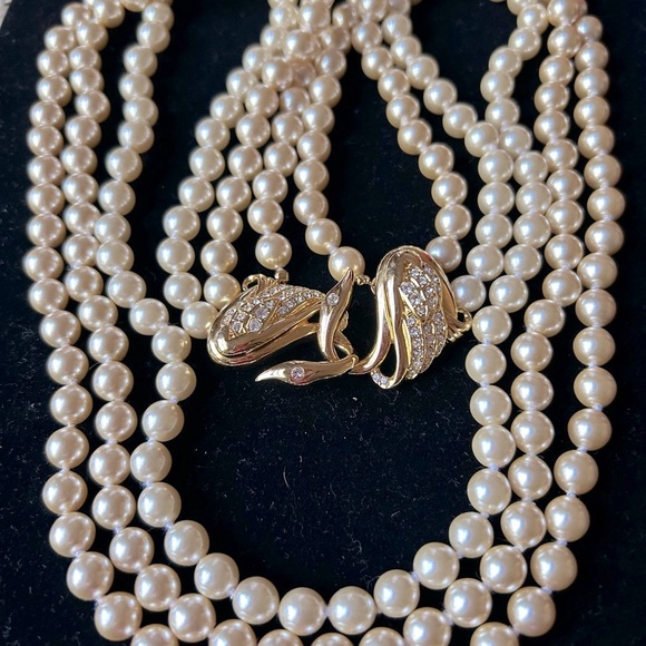 Vintage faux 3 strand peal necklace.
Approx 26" long. designer: Uksana - Picture 5 of 5